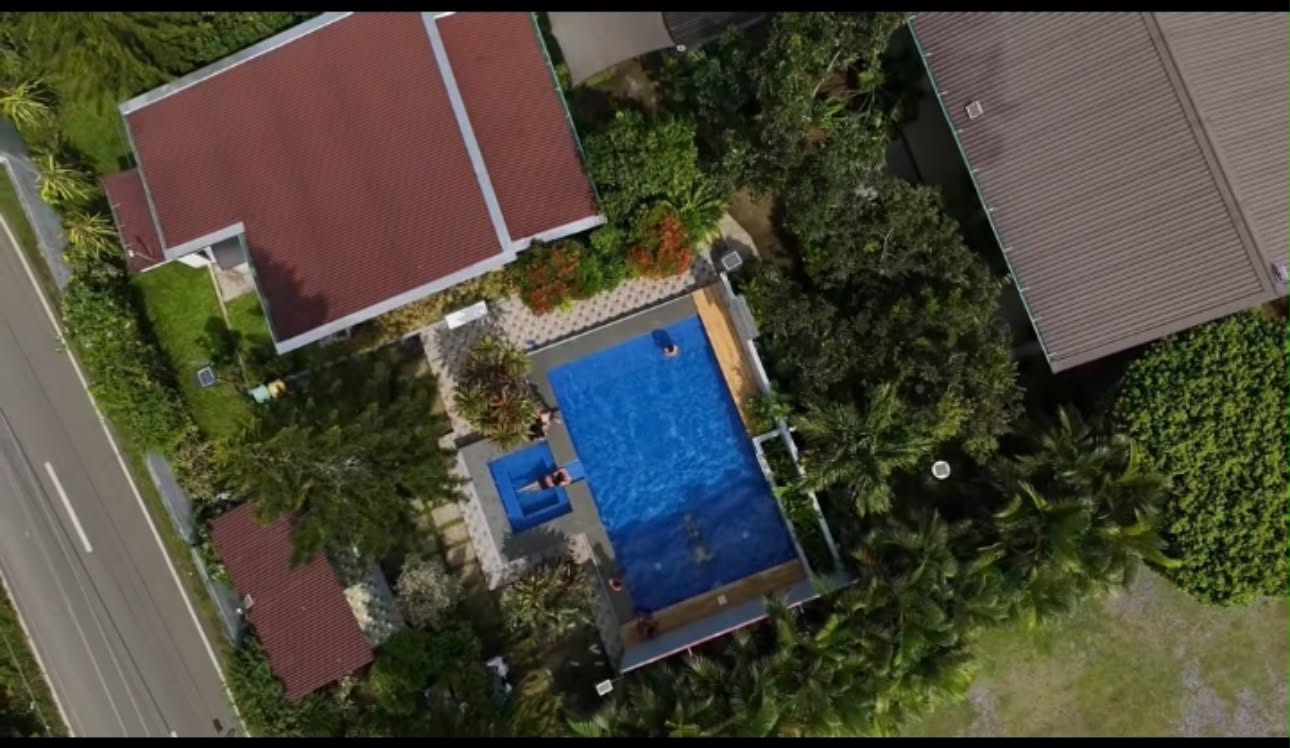 Aerial view of Villa 1 with pool and surrounding trees