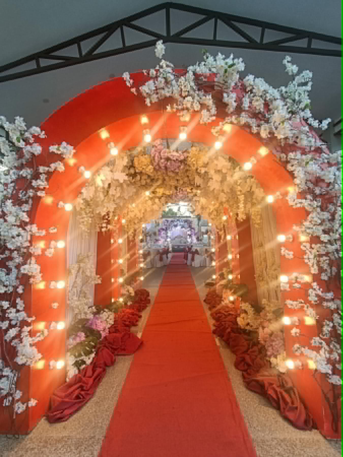 Villa 1 red carpet aisle with lighted arch decorations