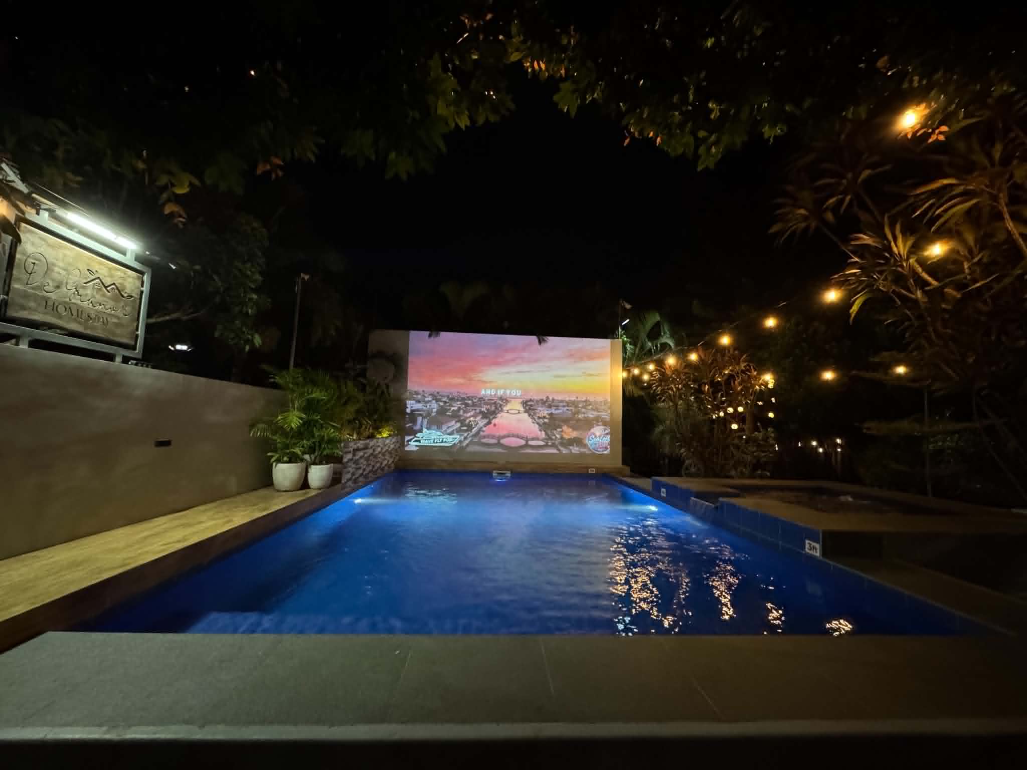 Villa 1 pool at night with widescreen movie setup