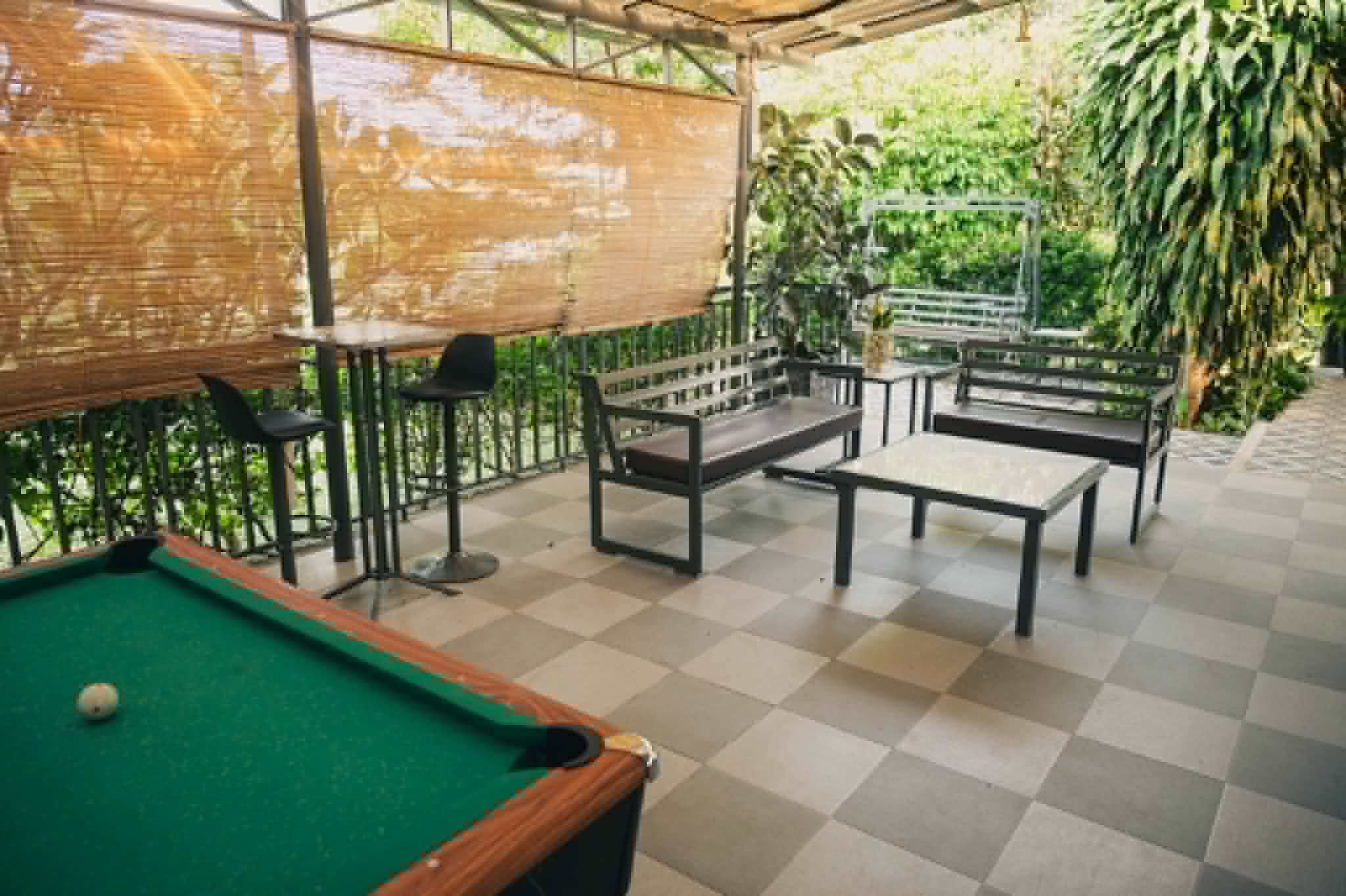 Villa 1 covered outdoor lounge area beside the billiards table