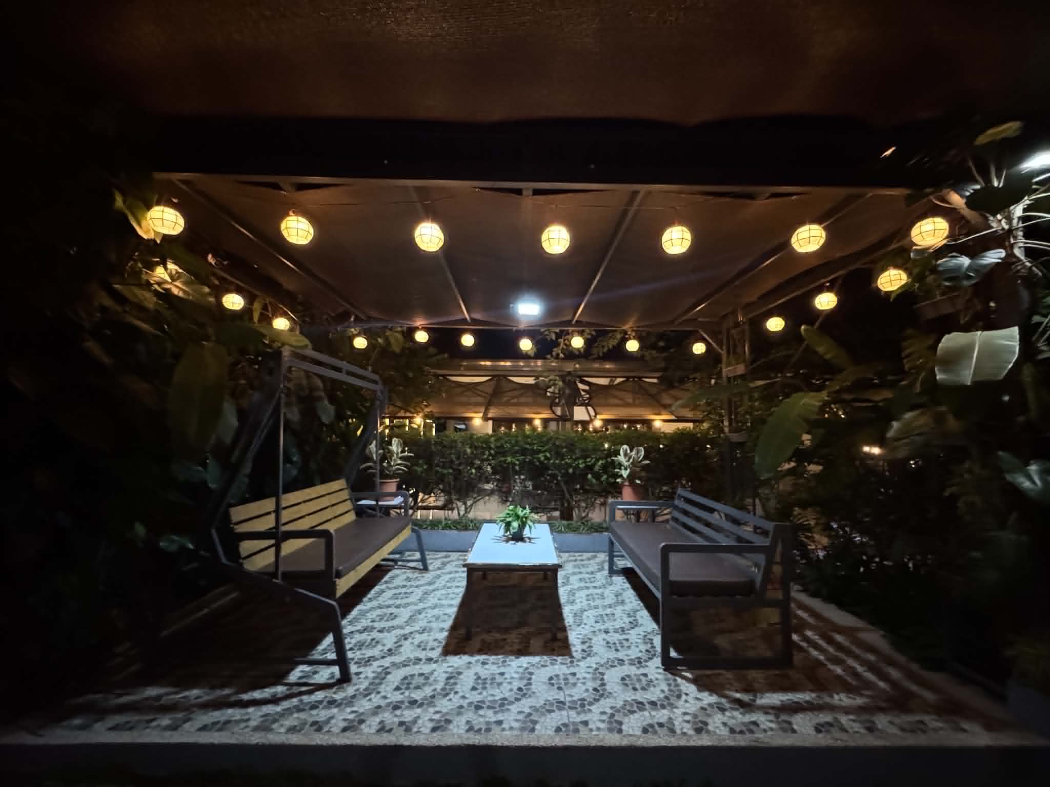 Villa 1 outdoor garden lounge with warm lights at night