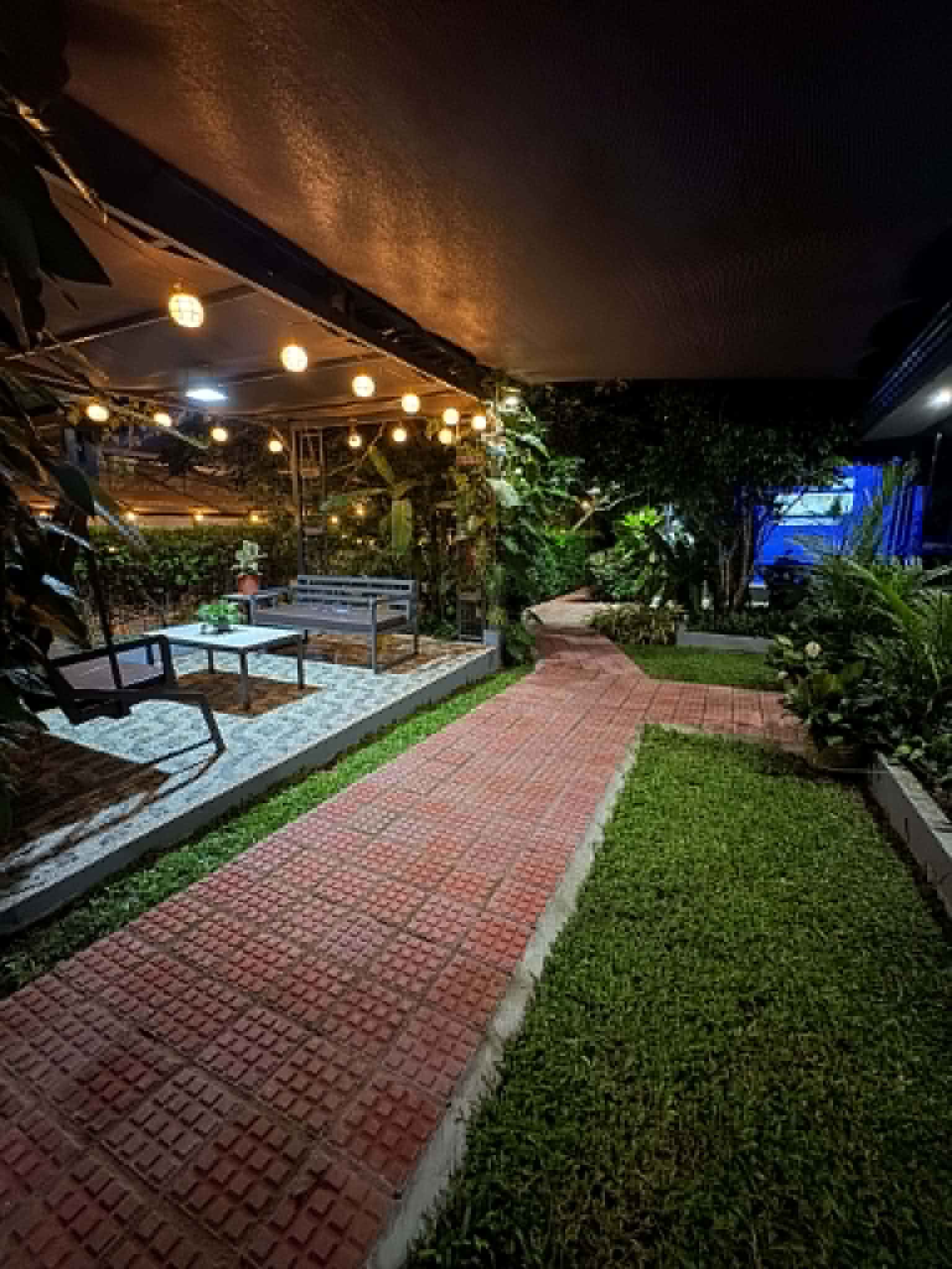 Villa 1 garden walkway and lounge lights at night