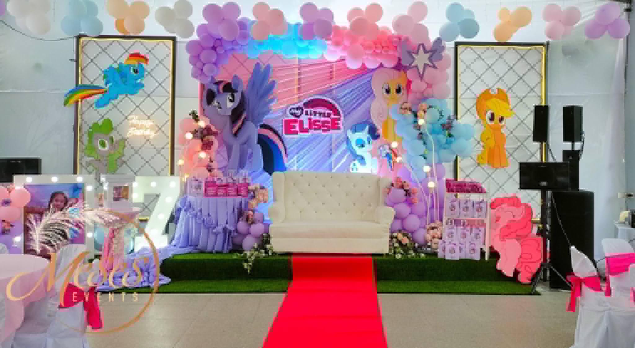 Villa 1 character-themed birthday stage with balloons and a red carpet