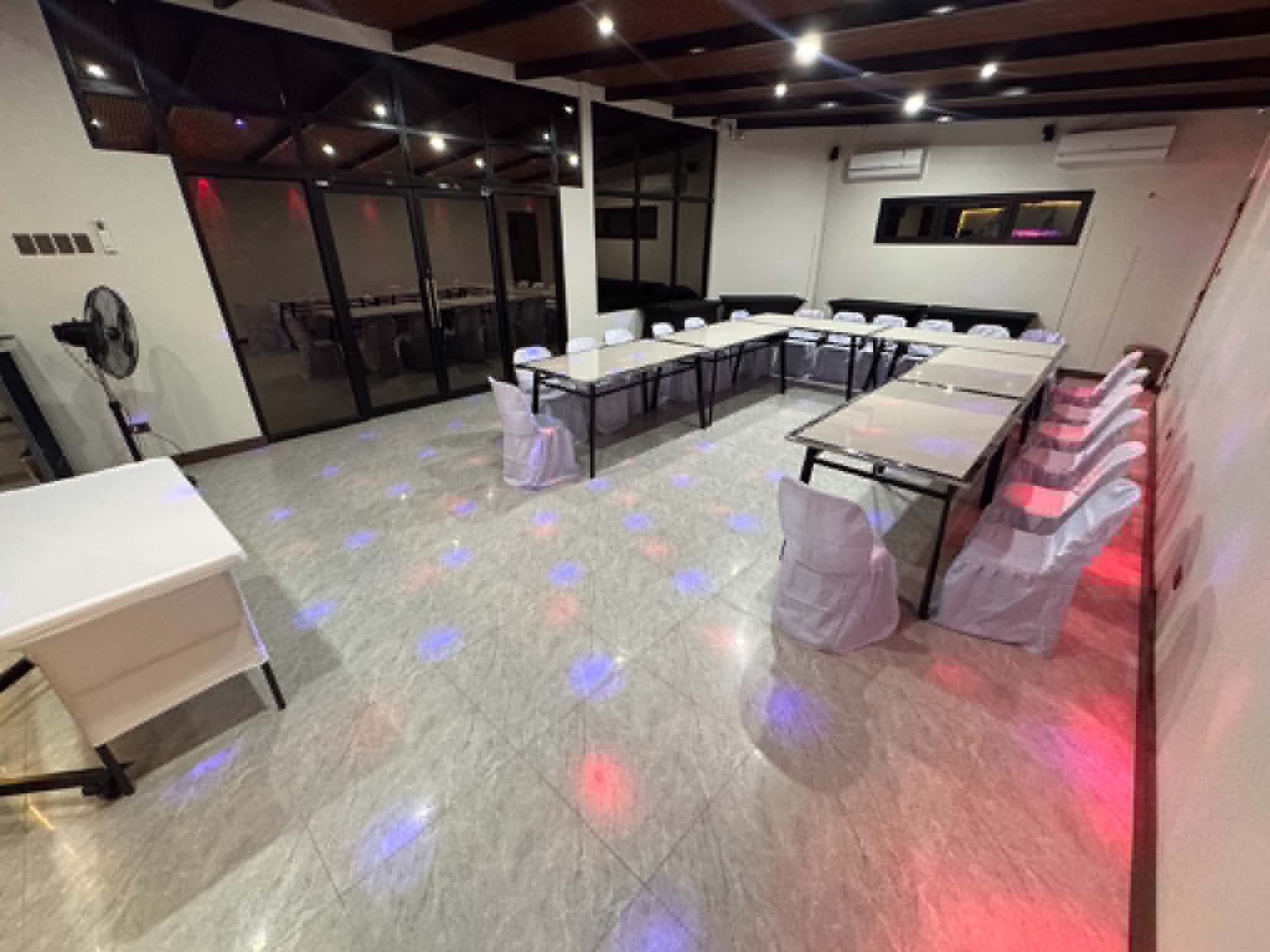 Villa 1 air-conditioned function room with event tables and chairs