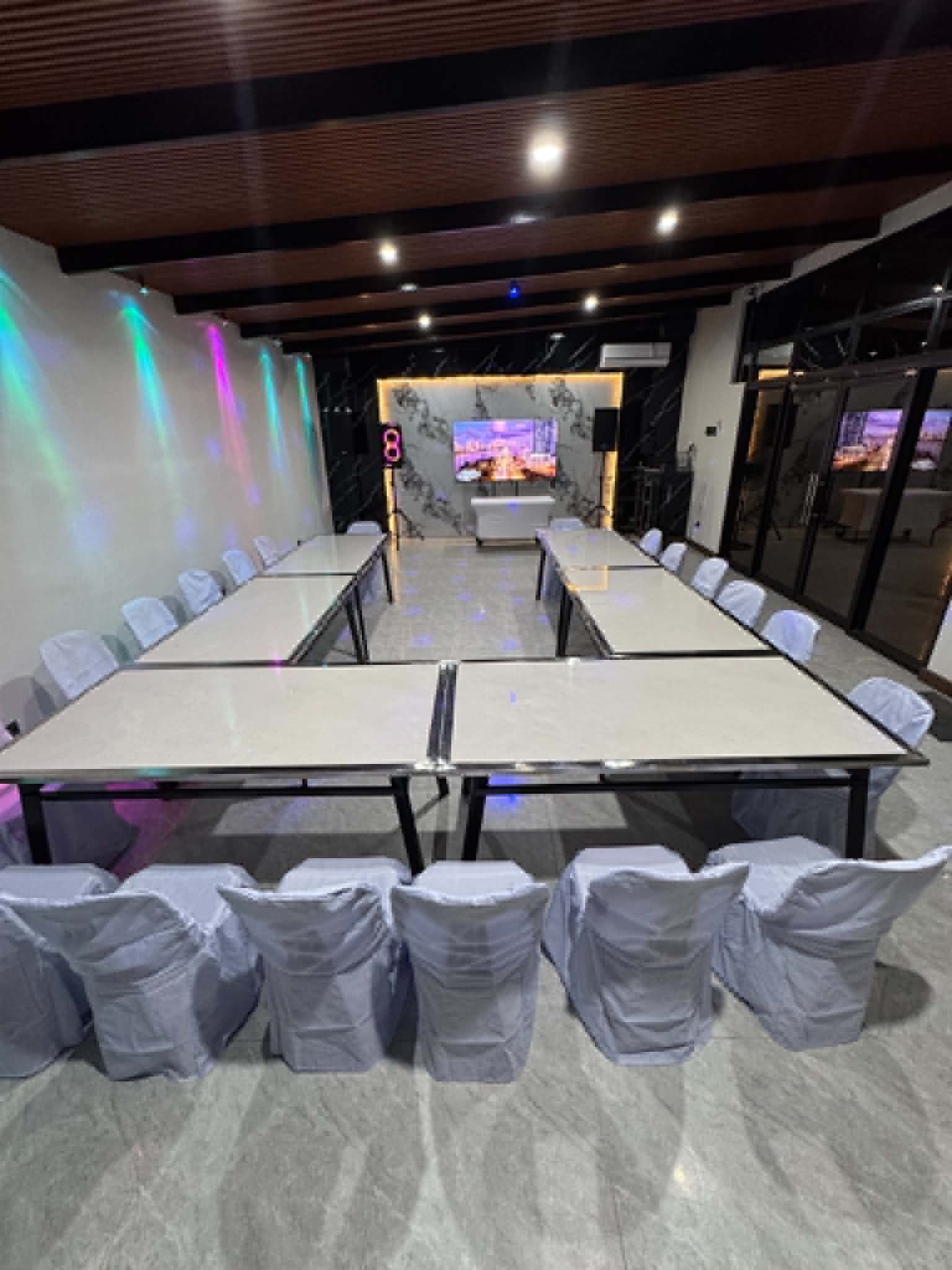 Villa 1 function room event setup with TV and speakers