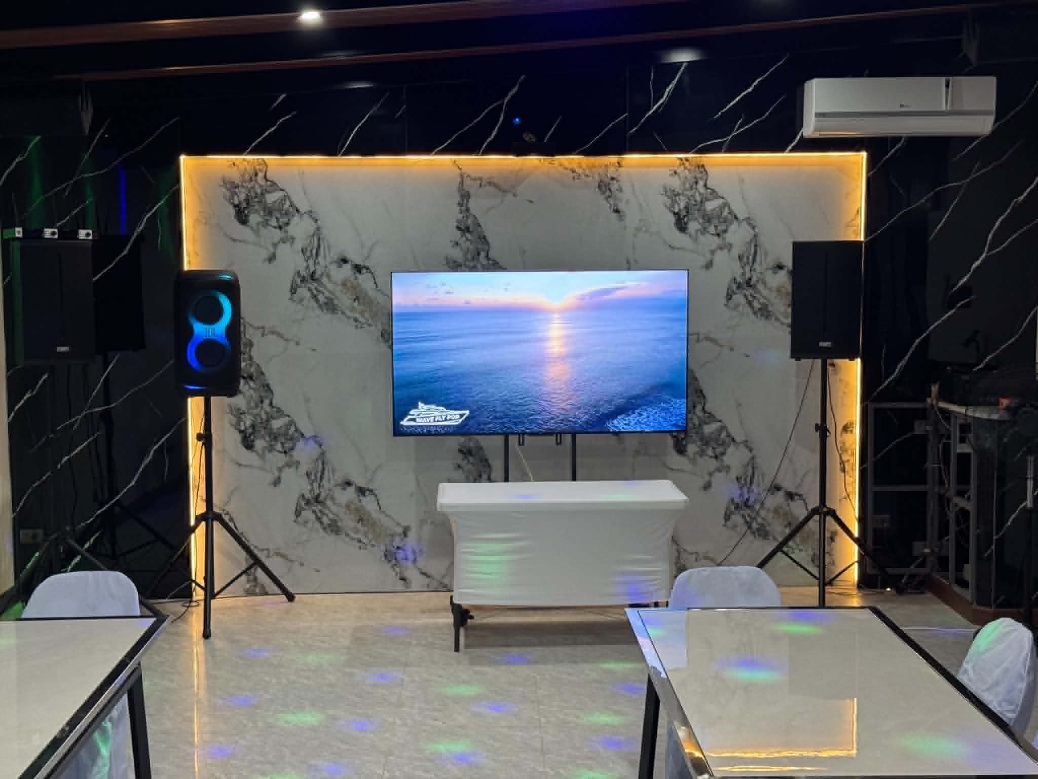 Villa 1 function room AV wall with TV and speakers
