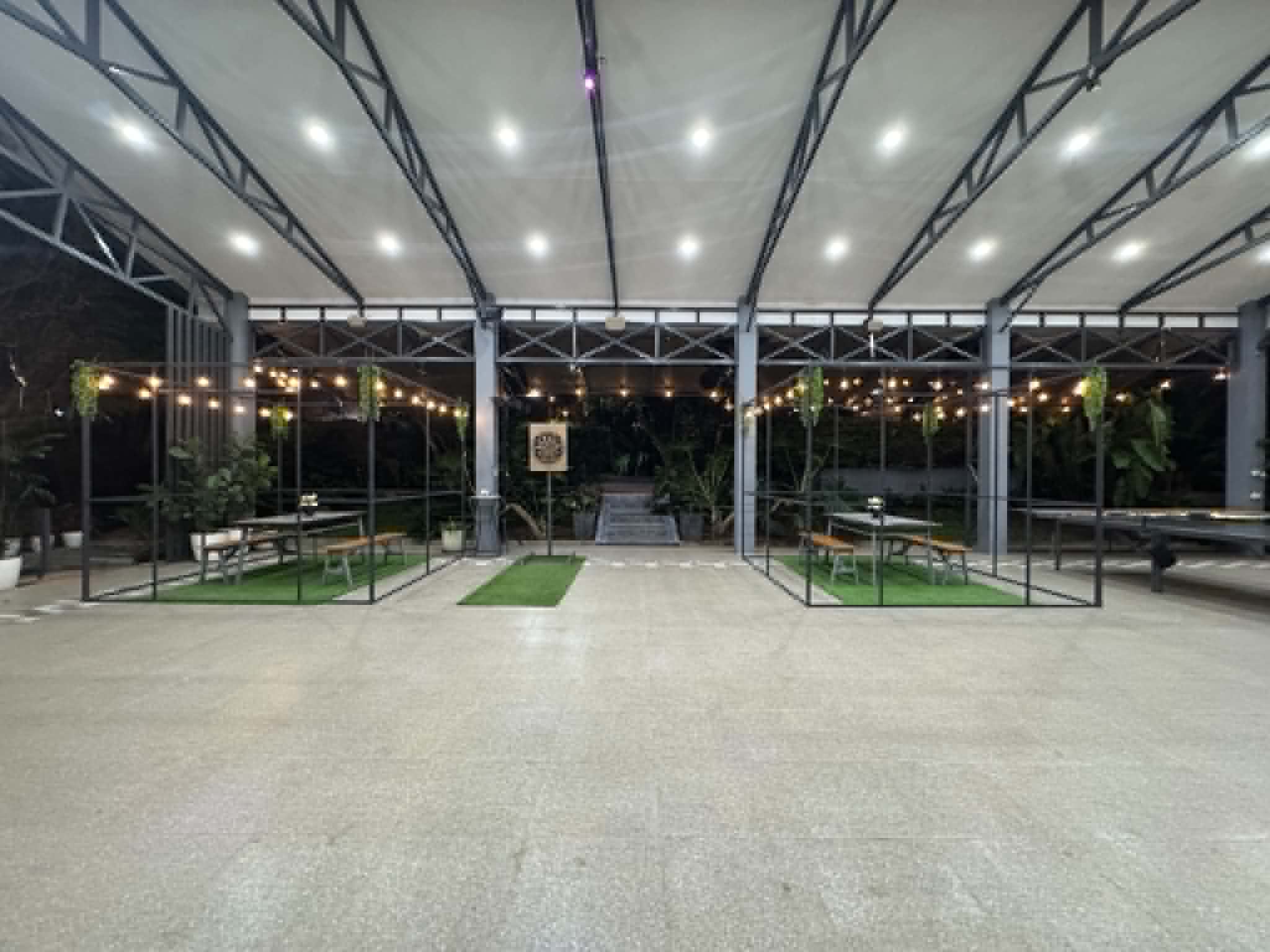 Villa 1 covered gathering area with seating at night