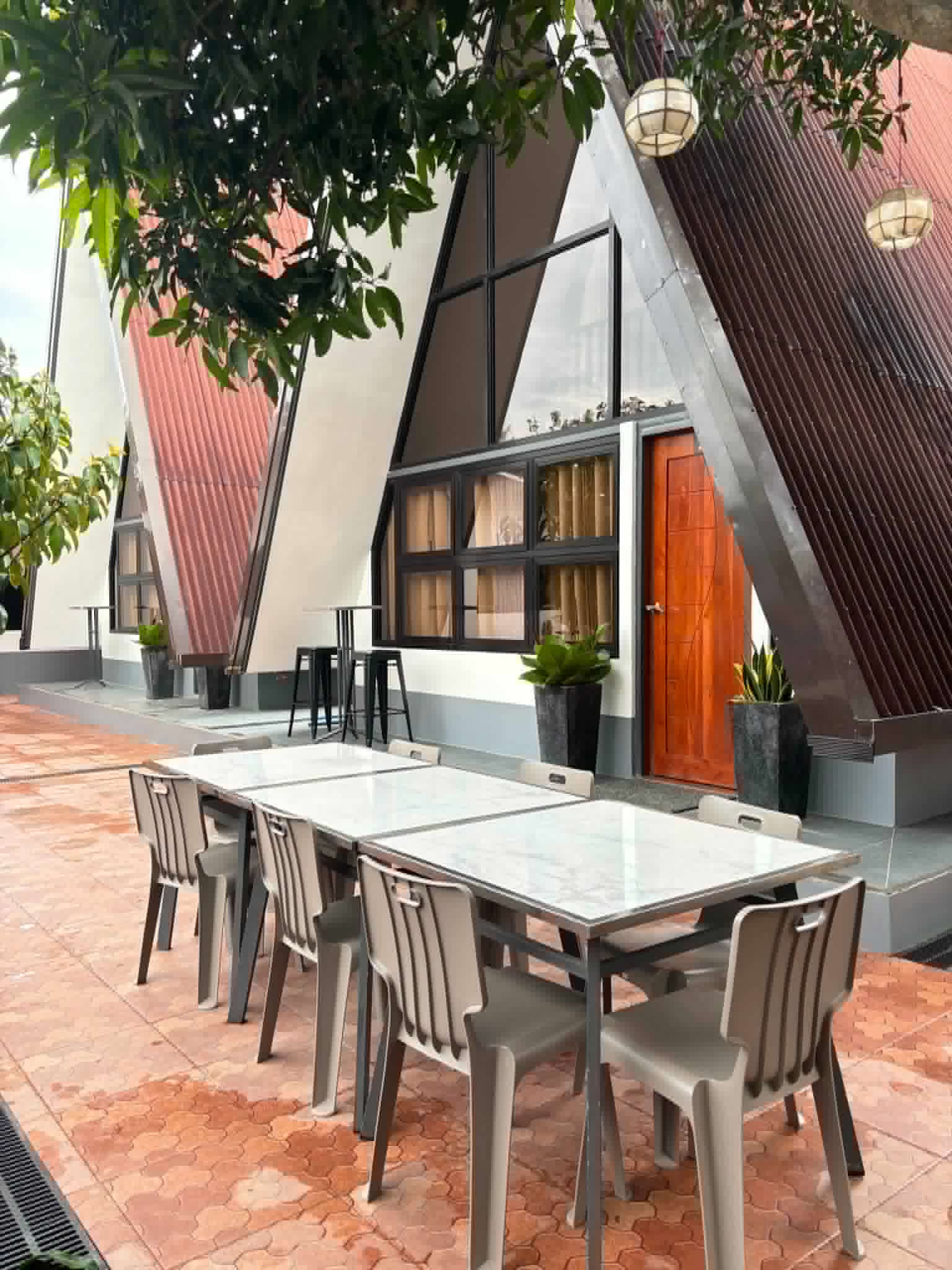 Villa 2 A-frame exterior with outdoor dining tables