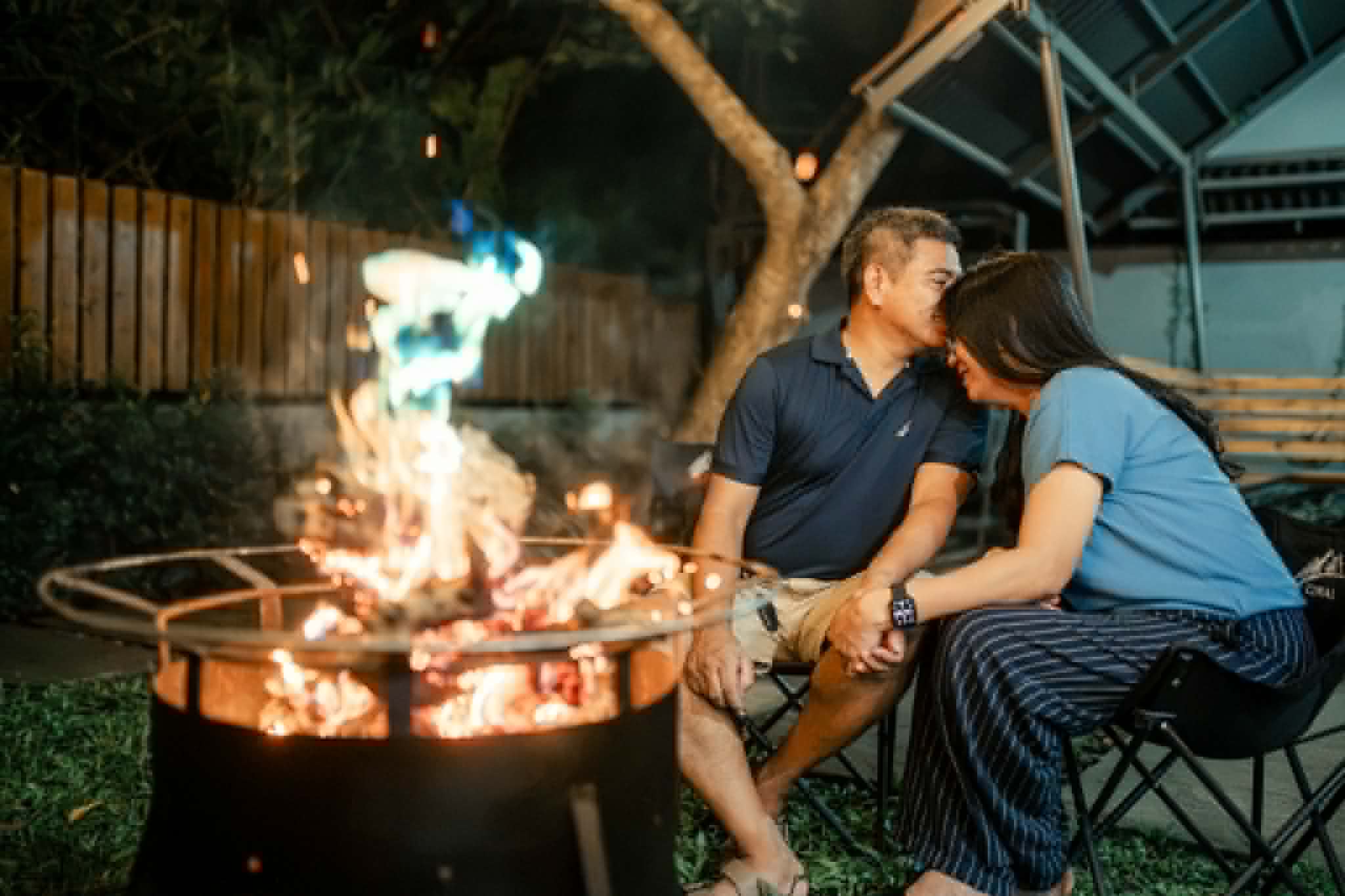 Villa 2 guests seated by the bonfire at night