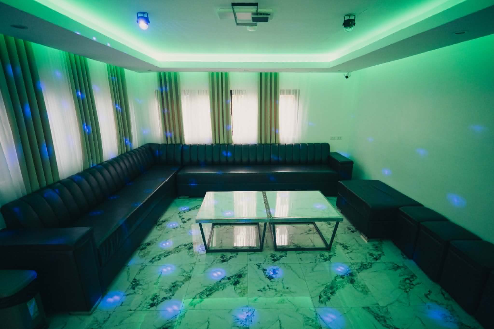 Villa 2 entertainment room with blue and green party lights