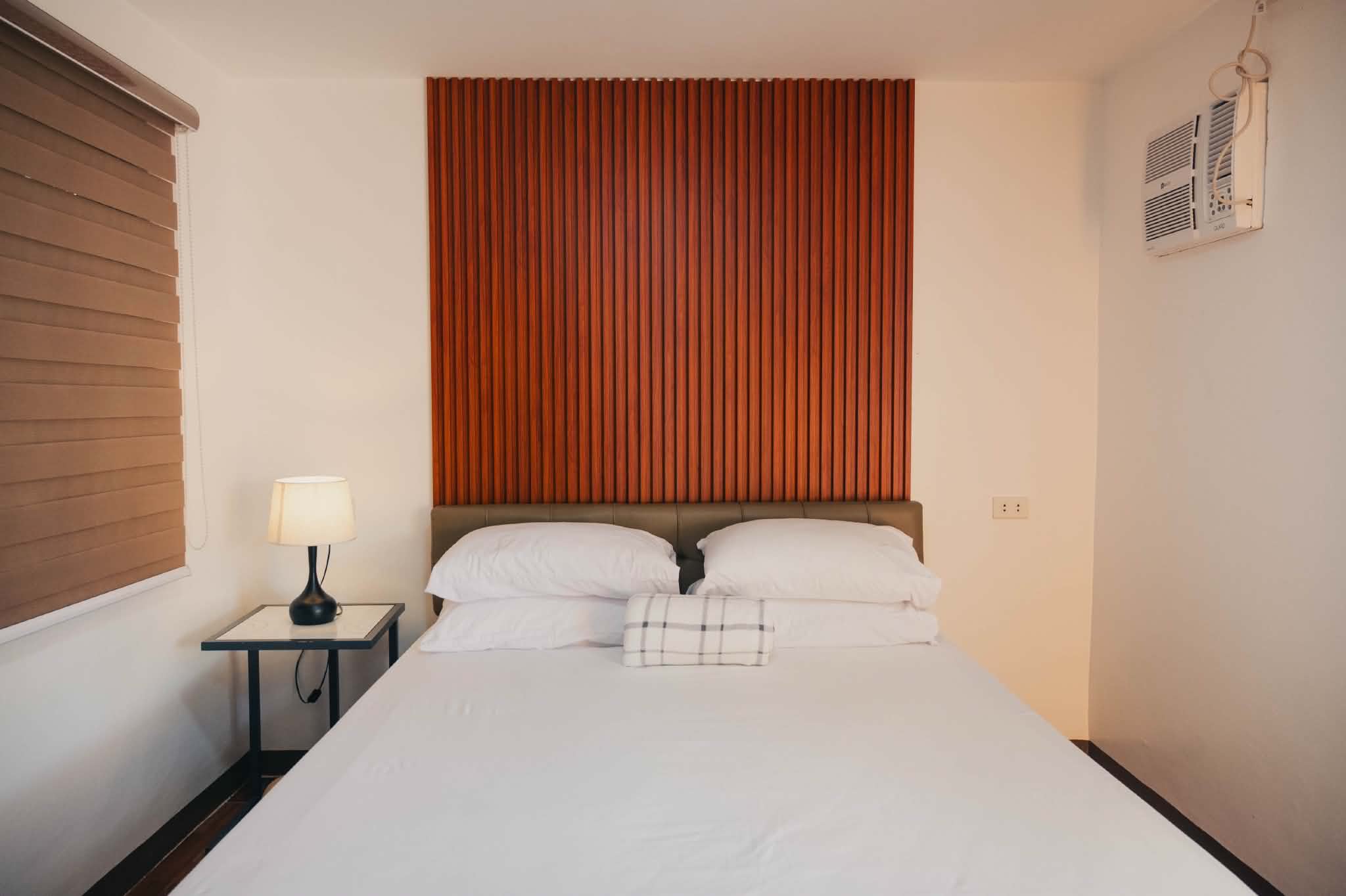 Villa 2 standard room bed with side lamp and air-conditioner