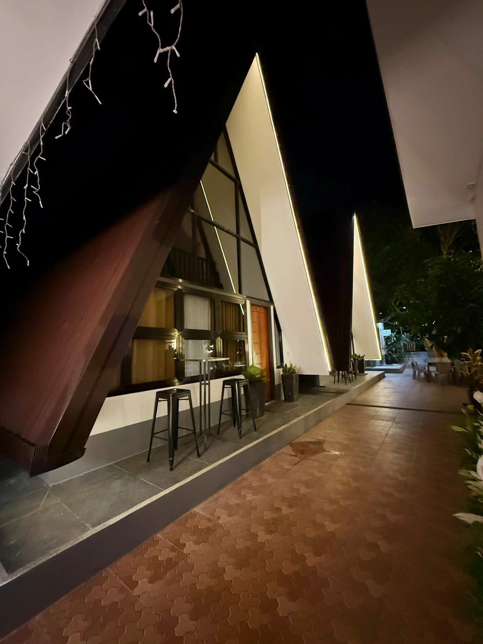Villa 2 walkway and A-frame exterior at night