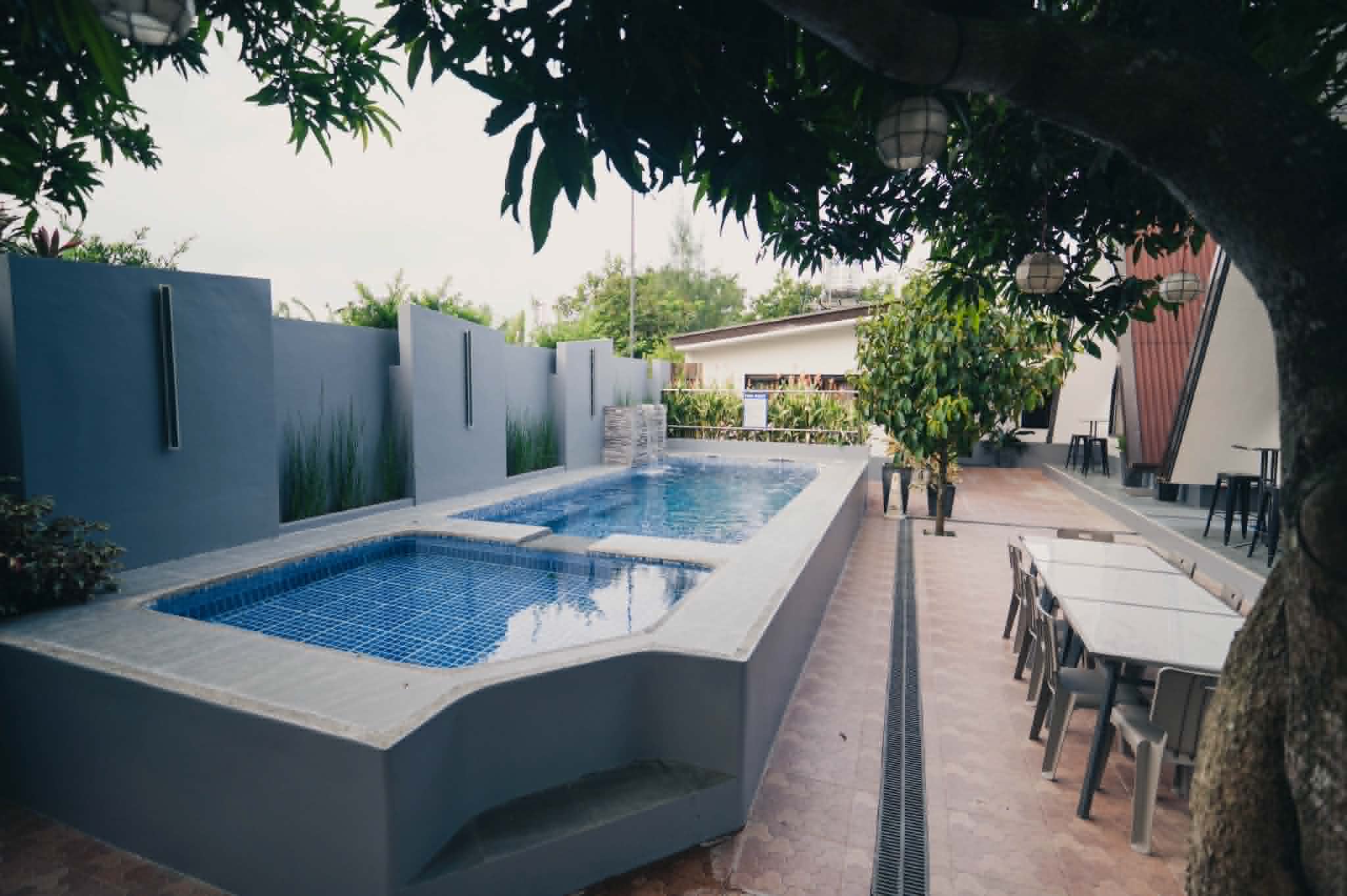 Villa 2 pool and patio dining area under shade trees
