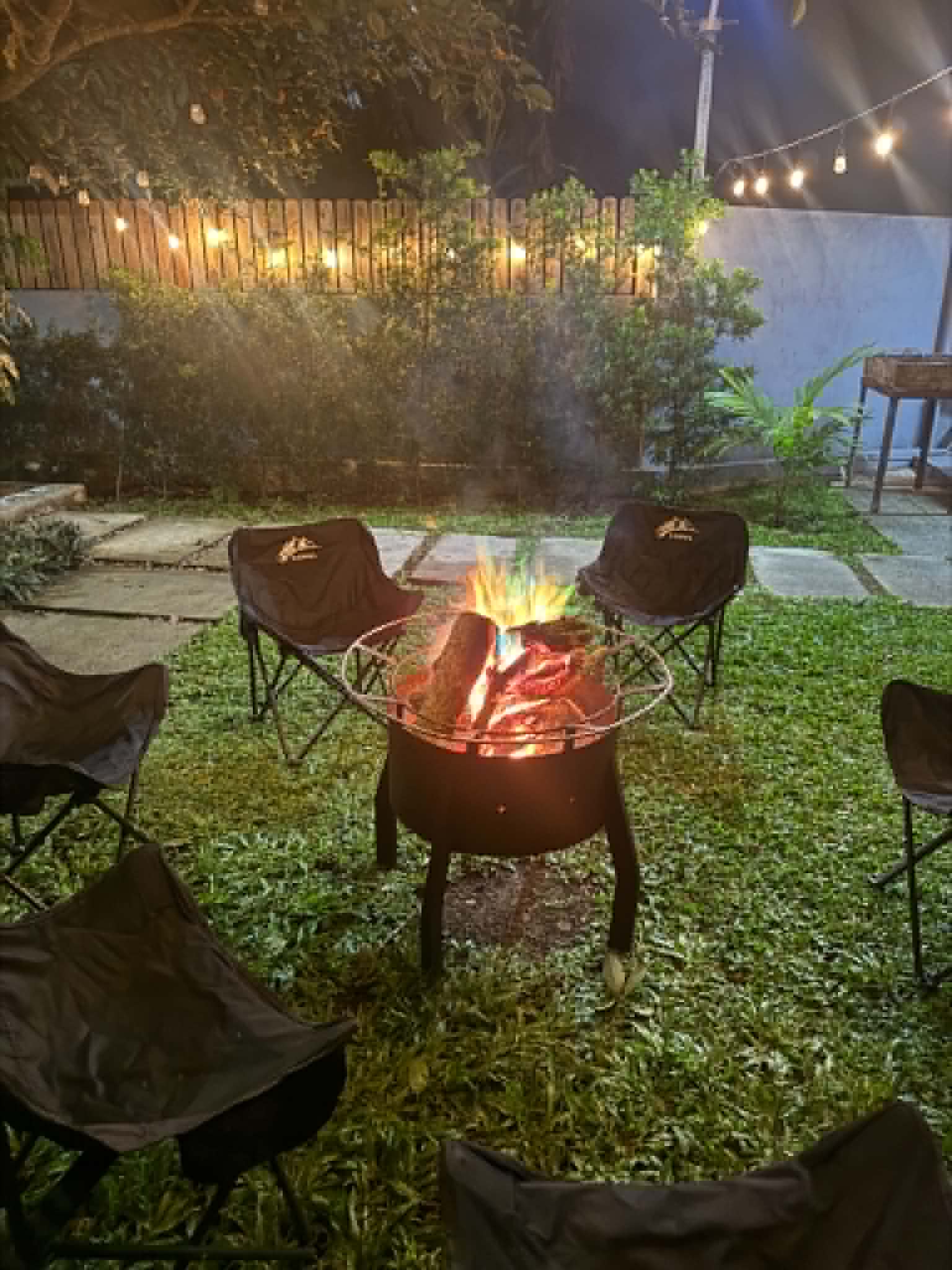 Villa 2 bonfire setup with outdoor chairs at night