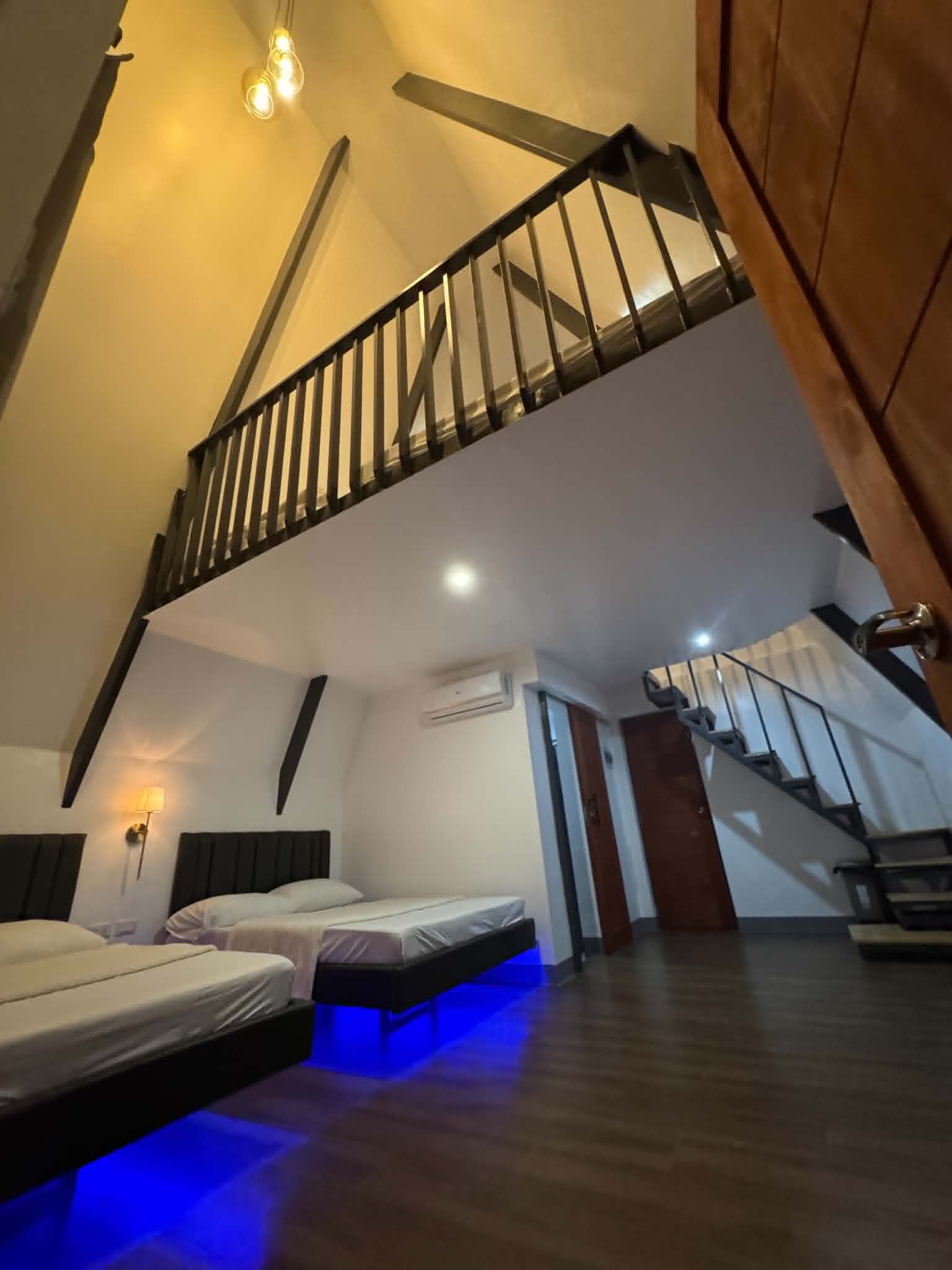 Villa 2 loft interior with beds and stairs