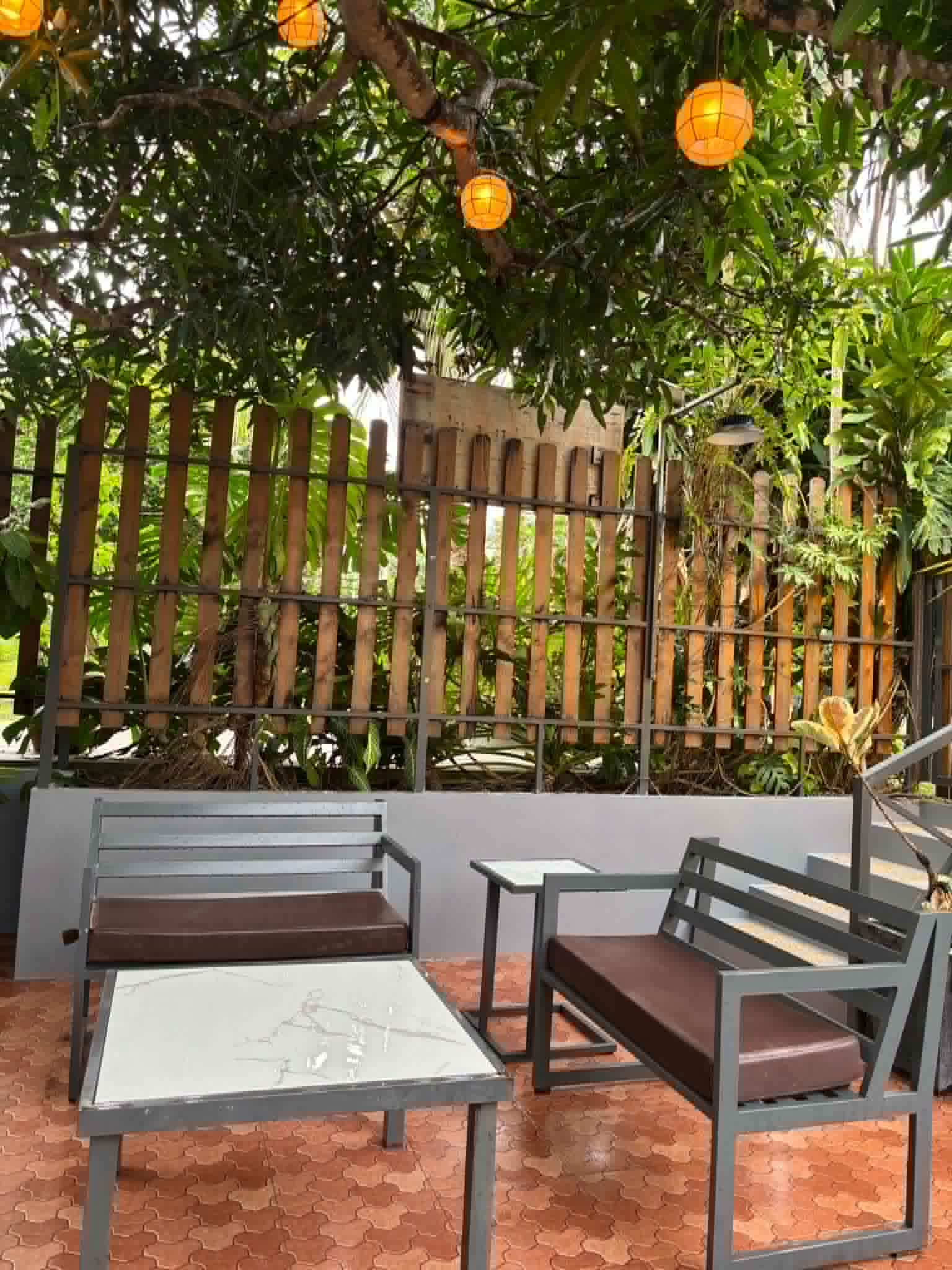 Villa 2 outdoor seating under trees